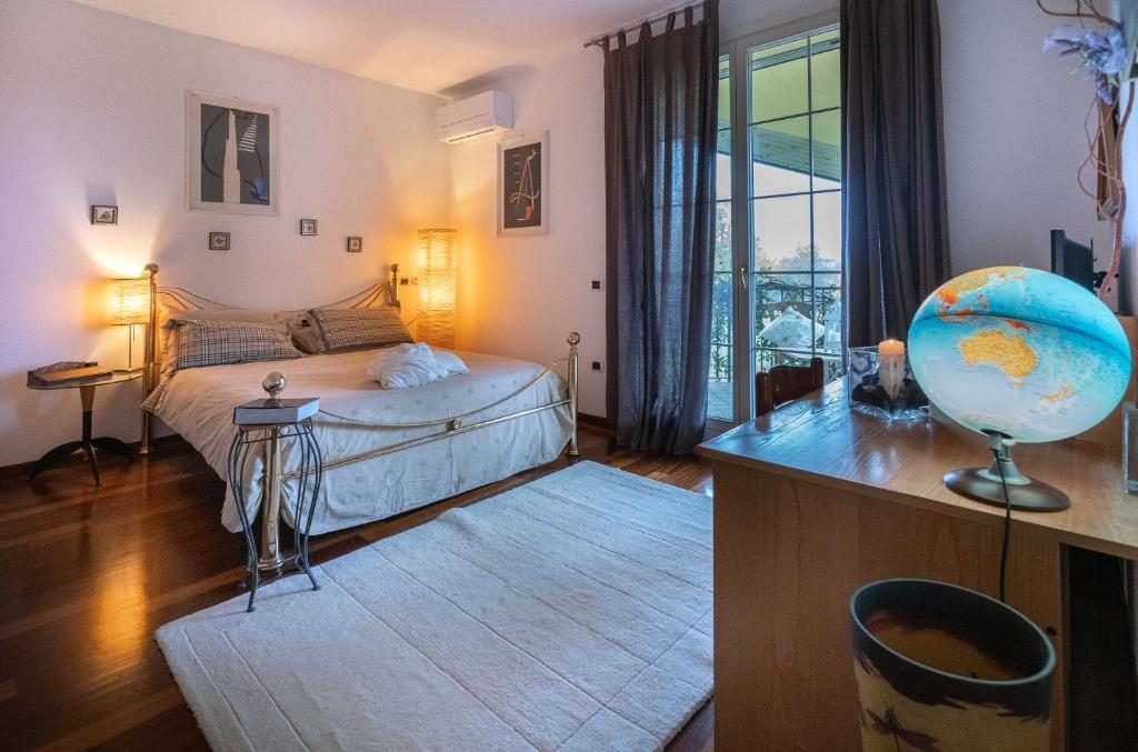 Camera matrimoniale con parquet, letto in ferro battuto e finestra sul giardino